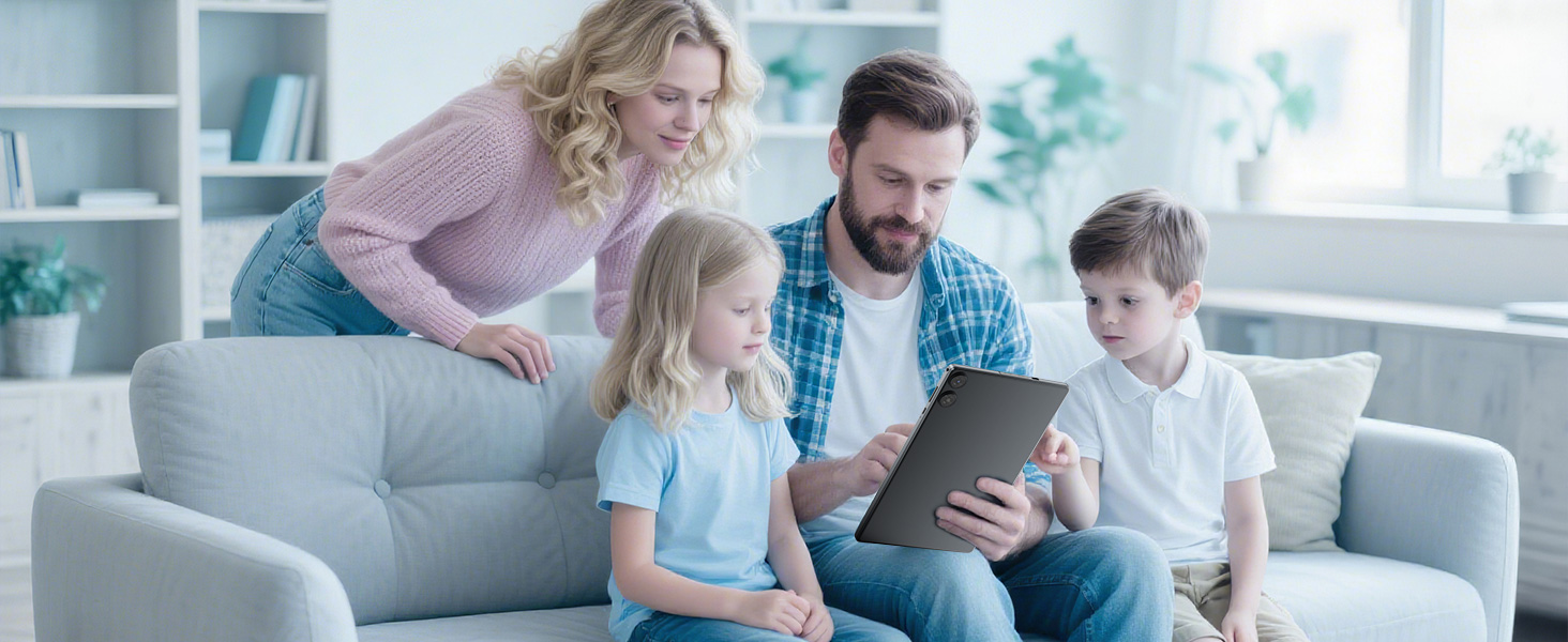Family gathered on gray sofa in living room, viewing content together on a tablet device in a well-lit room with bookshelves in background.
