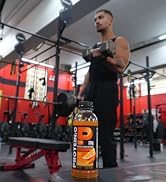 Close up of Protein sports drink with athlete working out in the background