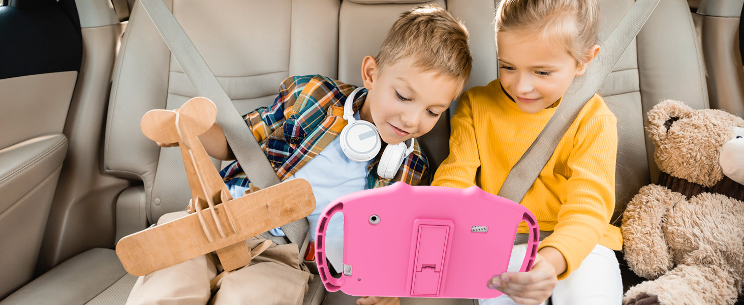 Two children sitting in car seats, playing with a pink tablet device secured by a protective case with handles.