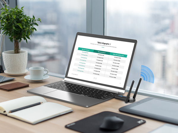 یک لپتاپ روی میز و یک لپتاپ دیگر روی آن.