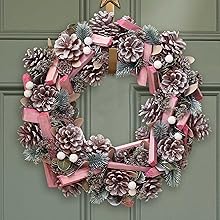 a pink and silver wreath with pinecones and silver beads