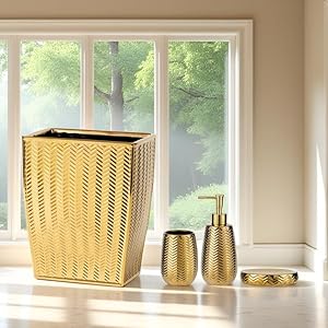 gold bathroom accessories and trash can