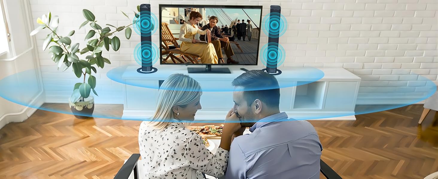 Home entertainment setup with large TV and blue speaker towers. Blue light effect surrounds viewing area. Herringbone wood floor and white brick wall visible.