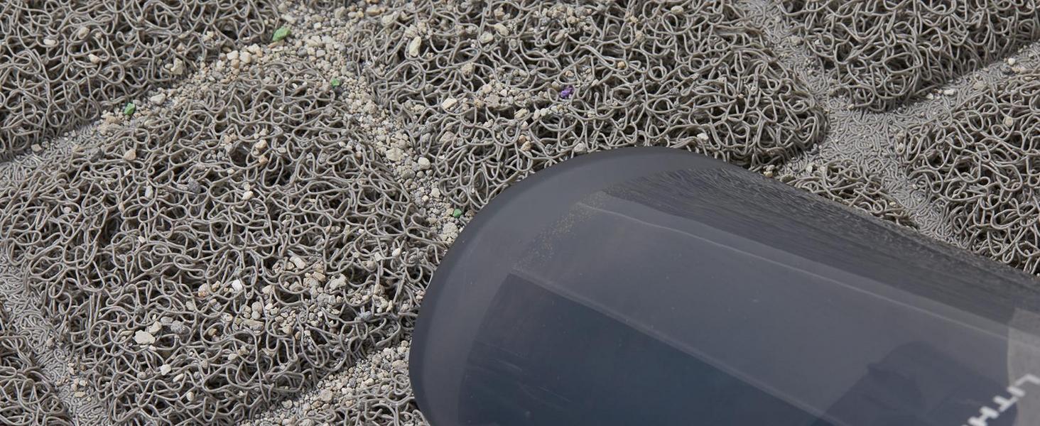litter tapped in cat litter mat with vacuum to show Easy Clean and less wasted litter