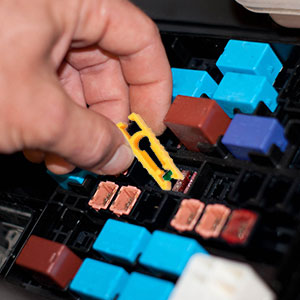 a hand is shown touching a yellow piece of computer keyboard.