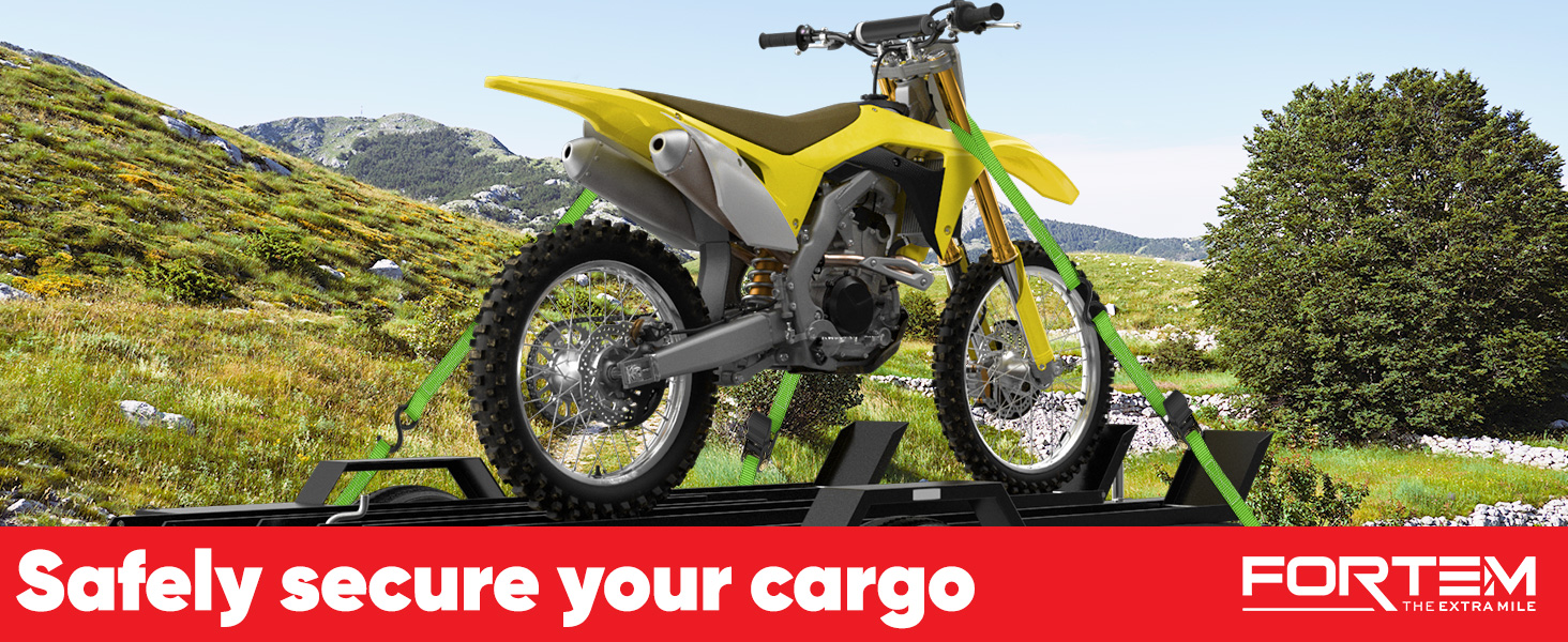 Motorcycle on top of a trailer being hauled with ratchet straps.