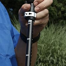 Trekking poles on rocky terrain showing durable aluminum alloy and tungsten carbide tips