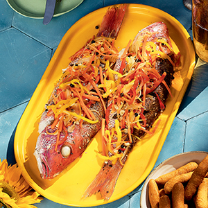 SNAPPER ESCOVITCH-ISH ON YELLOW TRAY ON BLUE TILE COUNTER