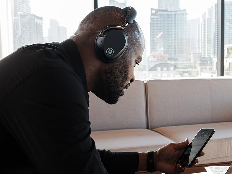 Man taking a phone call using his jlab epic lux anc headphones