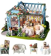 Detailed miniature outdoor patio diorama featuring white furniture, plants, and decorative elements under a blue structural frame.