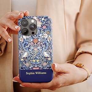 Smartphone case with intricate blue floral pattern and gold accents. Lower section in solid navy with 'Sophia Williams' text. Showcased on hand with neutral-toned background.