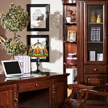 a home office with a desk and a lamp.