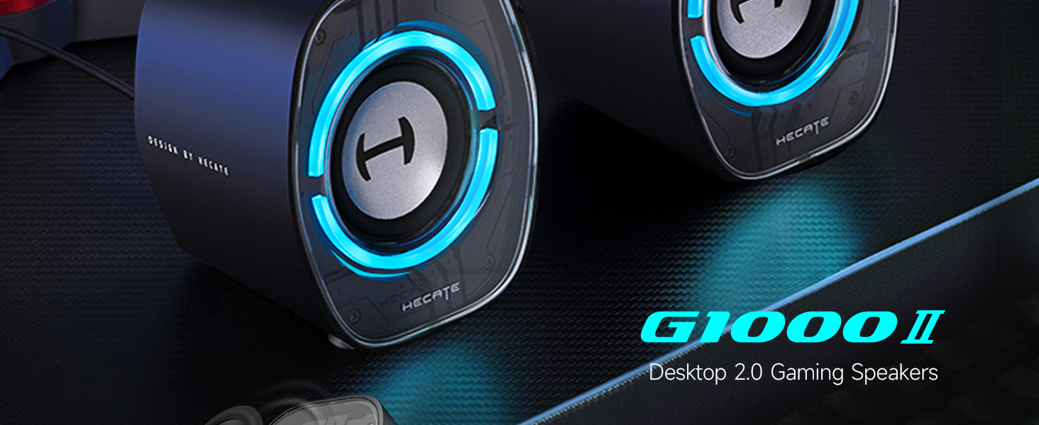 Text reads 'G1000II Desktop 2.0 Gaming Speakers'. Black gaming speakers with blue LED ring lights against dark background.