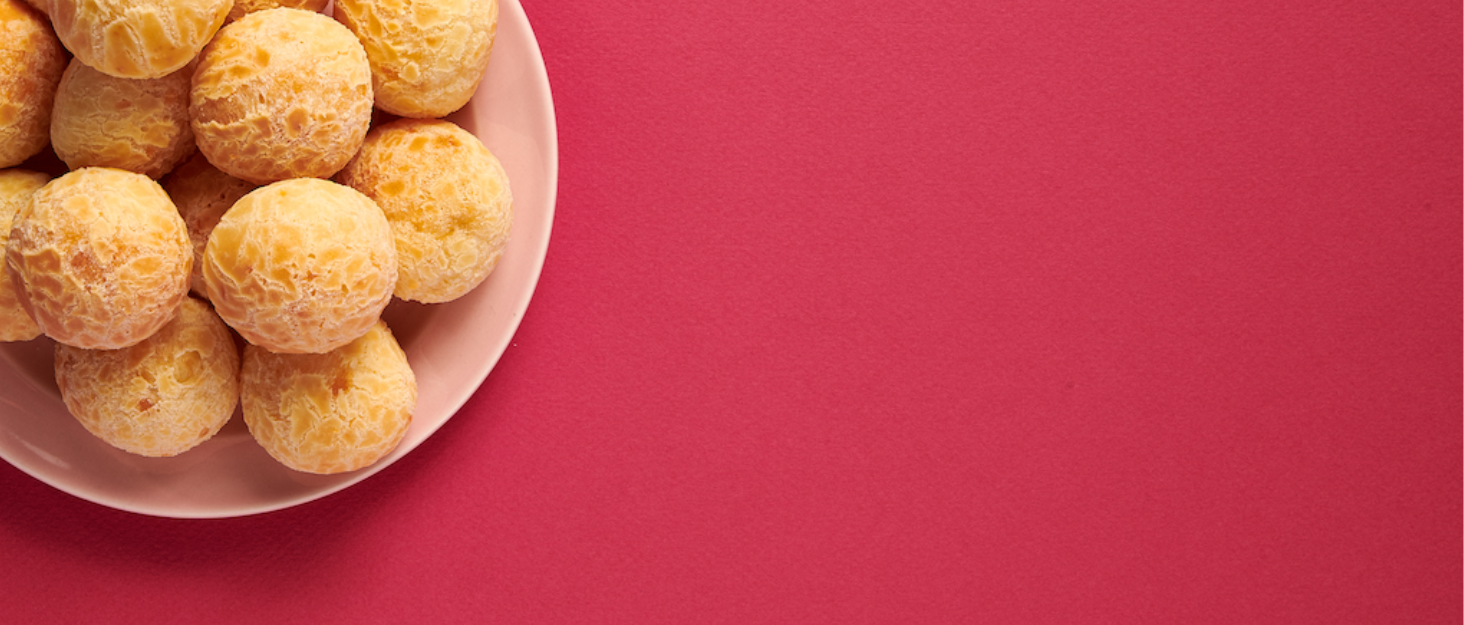 Plate of cooked cheese bread on plate with red background