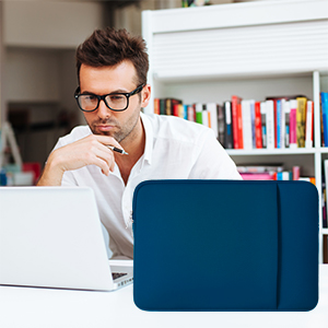 Blue laptop sleeve or case on a desk. A person in a white shirt is working on a laptop behind it, with bookshelves in the background.