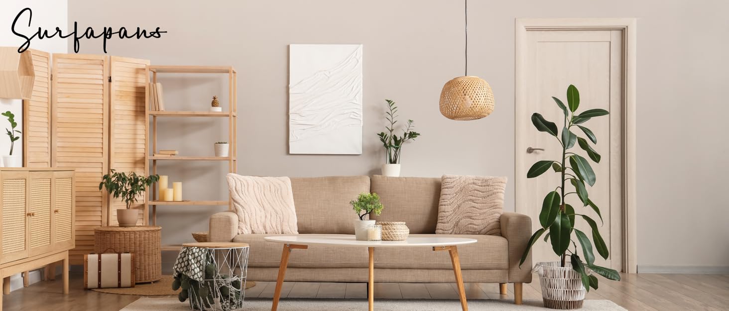 A cozy, minimalist living room with light wood furniture plants, a woven pendant, and neutral tones