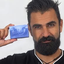Man holding up soap. 