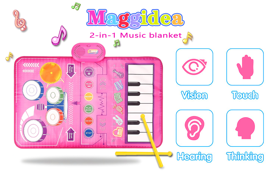 Pink electronic musical learning toy labeled 'Maggidea 2-in-1 Music Blanket' with piano keys and control buttons, featuring icons for vision, touch, hearing, and thinking.