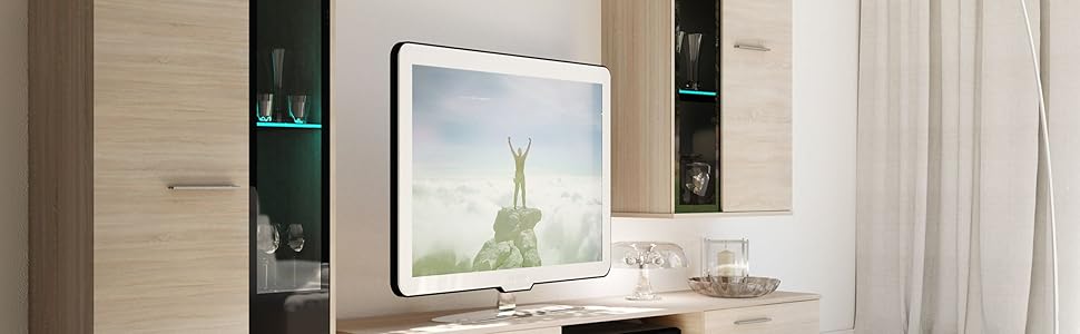 Modern light wood entertainment center with multiple cabinets, shelves, and a TV mount. The unit spans the wall and includes both open and closed storage options.