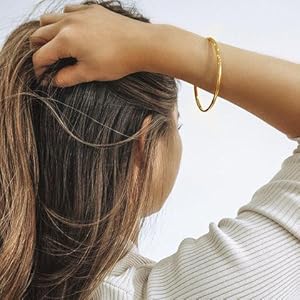 A 14k gold skinny bracelet, 3mm wide, 7 inches long.