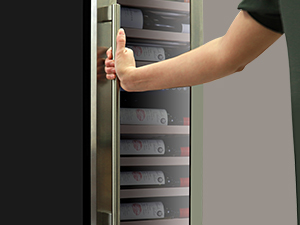 A person's hand holding the stainless steel handle of the Kenmore Elite premium dual zone