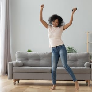 How to Set Up and Run a Successful Airbnb Business: Outearn Your Competition with Skyrocketing Rental Income and Leave Your 9 to 5 Job Even If You Are ... Hosting & Real Estate Investing Strategies) 10 Woman happy in a livingroom of an airbnb