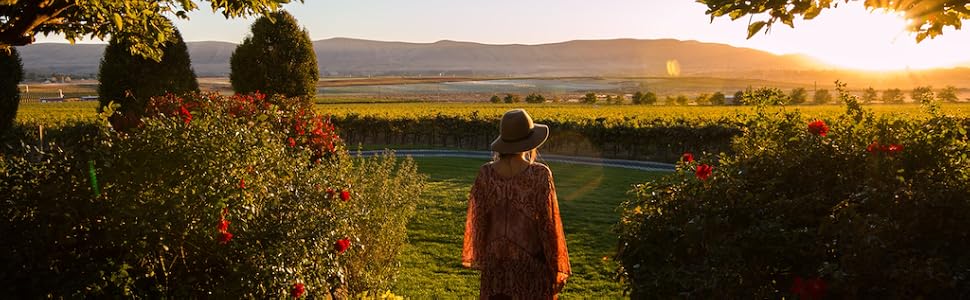 Woman overlooking vineyard.