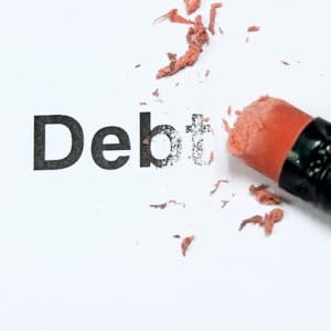 Pencil eraser erasing the word debt