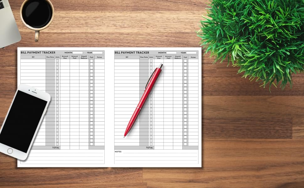 OPEN BILL PAYMENT TRACKER BOOK ON A DESK