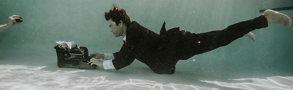 Boo Walker typing underwater.