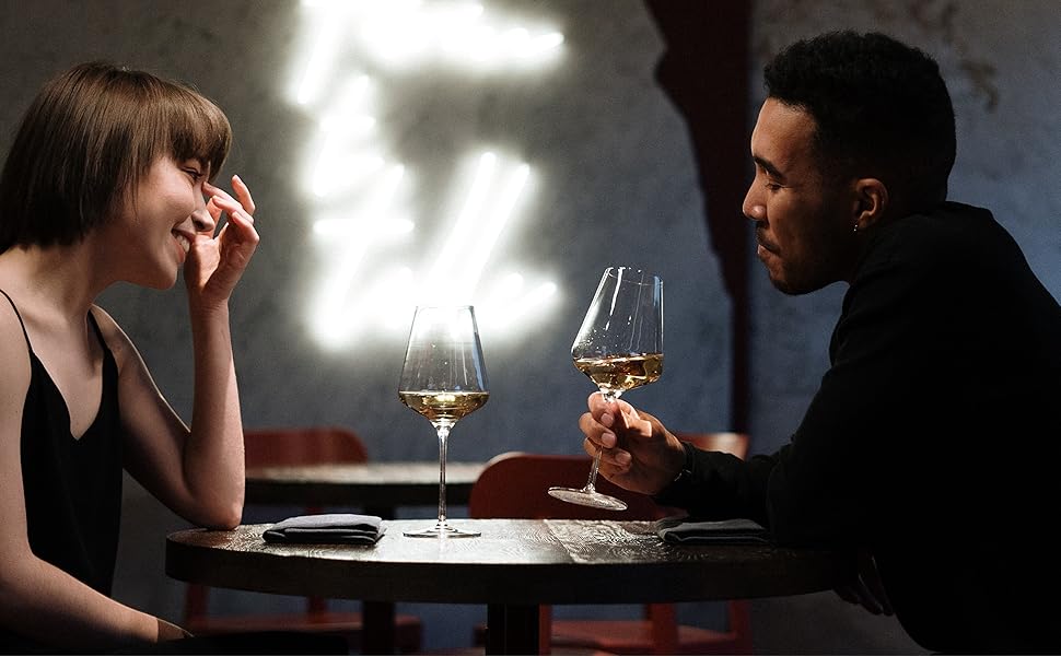 Couple sharing drinks at a table on a date