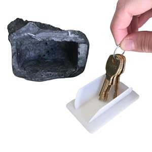 keys on plastic cover next to fake rock