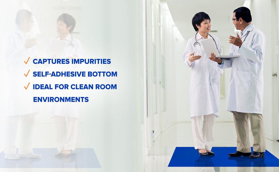 doctors standing on a blue tacky mat in a hallway of a hospital or clinic
