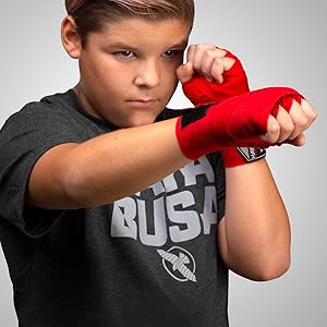 Image of boy shadow boxing with Red Kids handwrap
