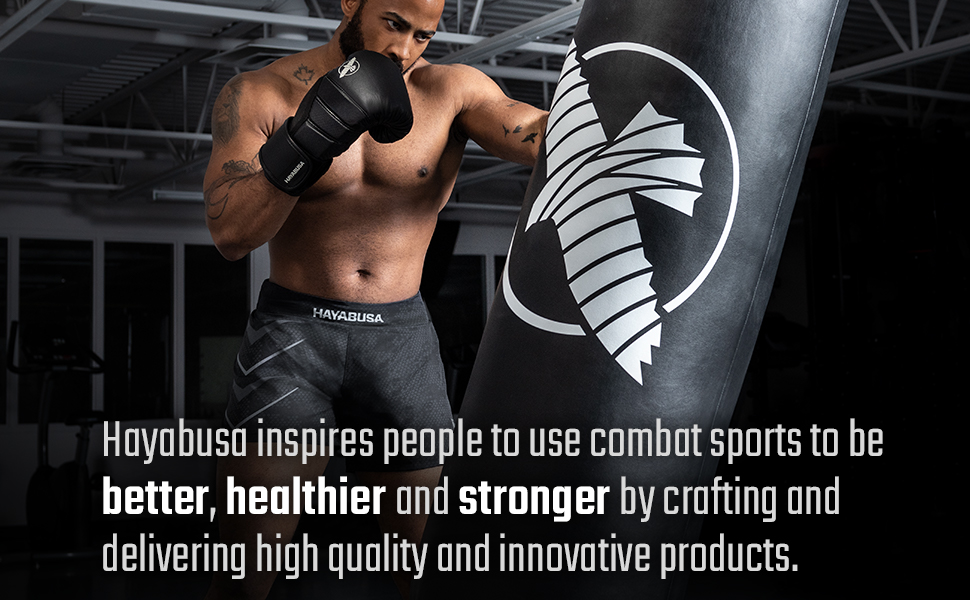 Male punching heavy bag wearing black Hayabusa Arrow Kickboaxing Shorts