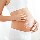 applying ellastibelly in circular motions over belly stomach area gently in massaging motions