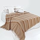 Beigefarbener Überwurf auf dem Bett.