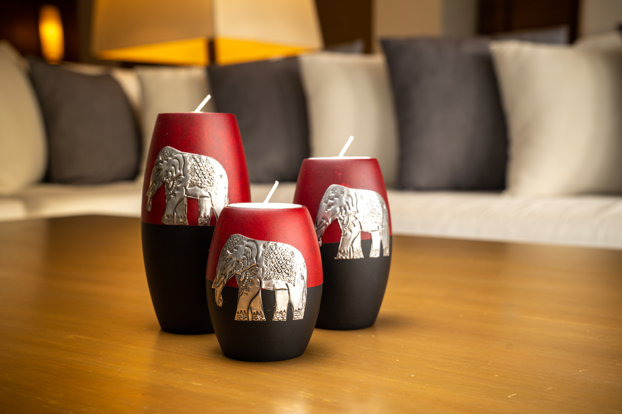 A wooden candle holder with a grey pixel design.