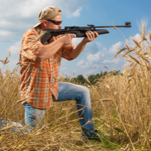 MAN in reading sunglasses aims rifle