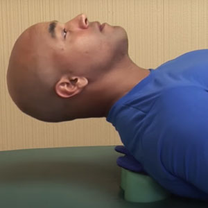 Man laying down on Sport Deep Tissue device