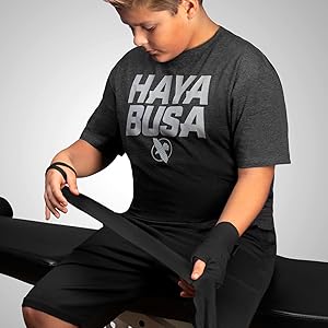 Image of youth kid starting to wrap hands black Boxing hand wrap