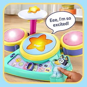 Kid pushes Bluey button on drum base. Toy drum says: Eee, I’m so excited!