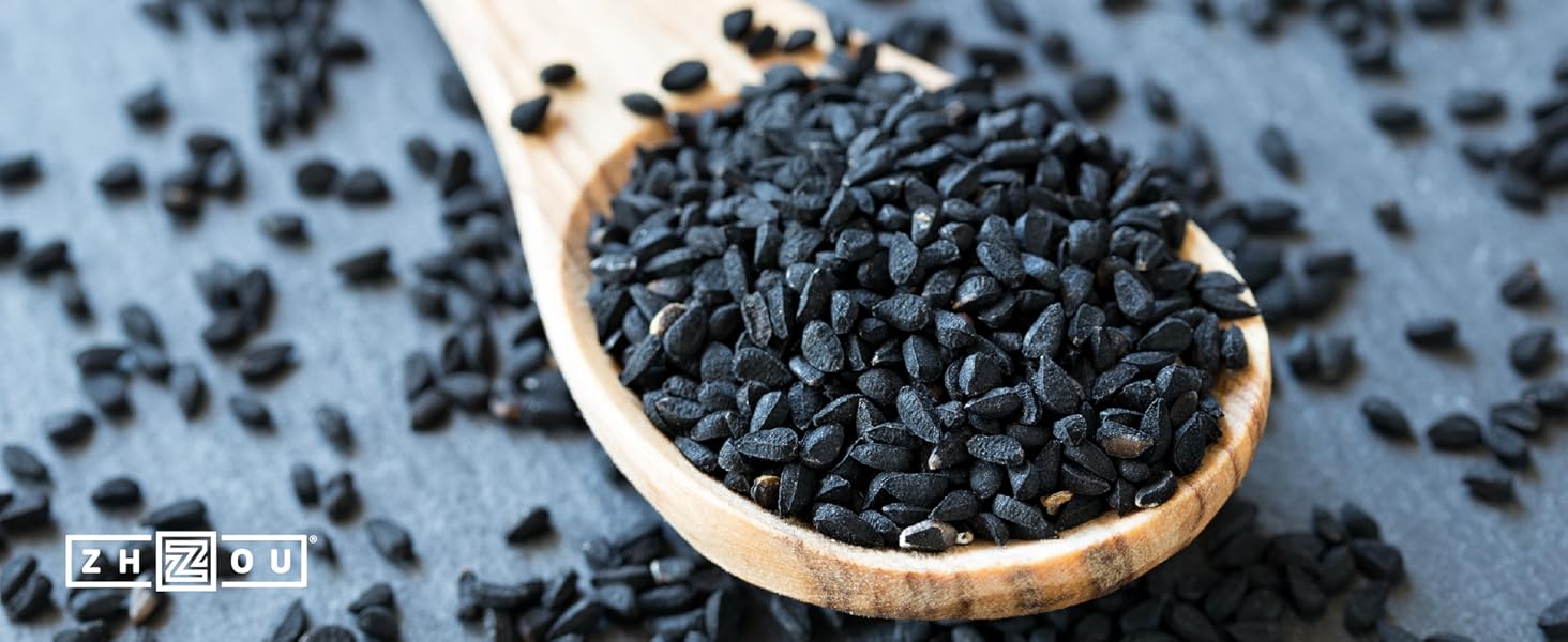 Black Cumin Seeds on wooden spoon.
