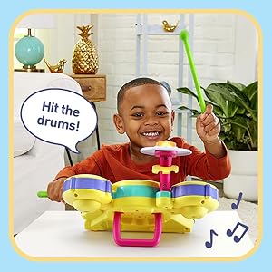 Kid plays toy drum on Free Jam mode. Toy drum says: Hit the drums! As he experiments with beats.