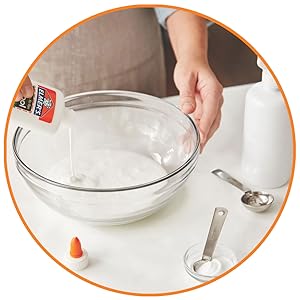 person adding glue to bowl