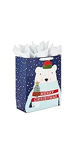 Rustic Christmas gift bag with polar bear on blue background holding a Christmas tree