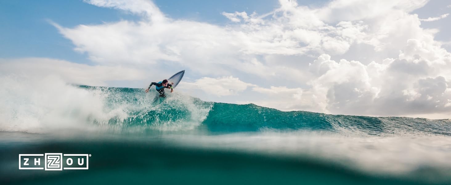 Surfer riding the waves in the beautiful blue green ocean in California.