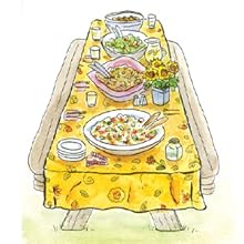 a set table with a salad, flowers, and more