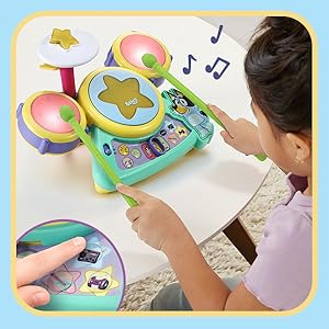 Kid experiments with drum settings and experiences different drumbeats.