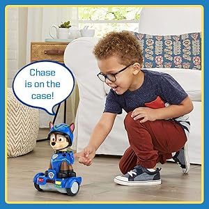 Kid watches as Chase rolls away. Red and Yellow lights flash. Toy says: Chase is on the case!